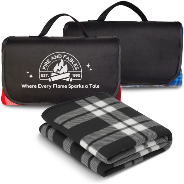 A black and red picnic blanket featuring a tartan pattern, neatly folded and displayed with a carrying handle.
