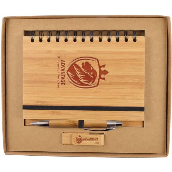 A bamboo notebook with a spiral binding, a pen, and a wooden USB drive, all packaged in a sturdy box.