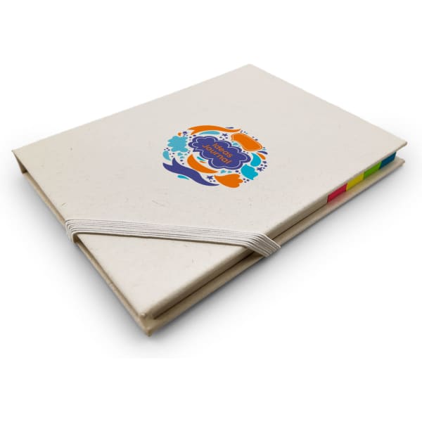 A beige daily planner with a colourful circular logo on the cover and an elastic band. Tabs in various colours are visible.