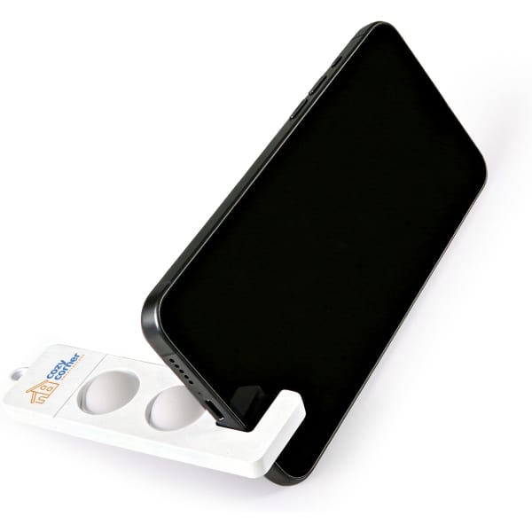 A white phone stand holding a smartphone, featuring a logo on the side. The design is simple and functional.