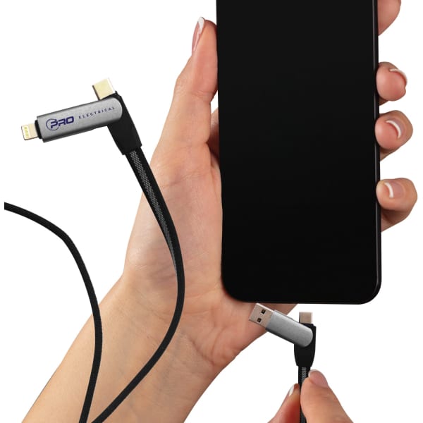 A hand holds a black Volt Combo Cable, connecting it to a smartphone with a sleek, black screen.