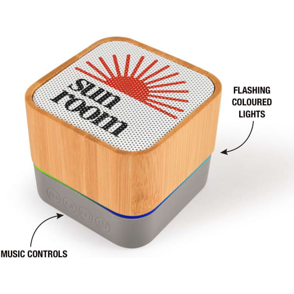 A square Bluetooth speaker with a bamboo casing, featuring colourful flashing lights and music controls at the bottom.