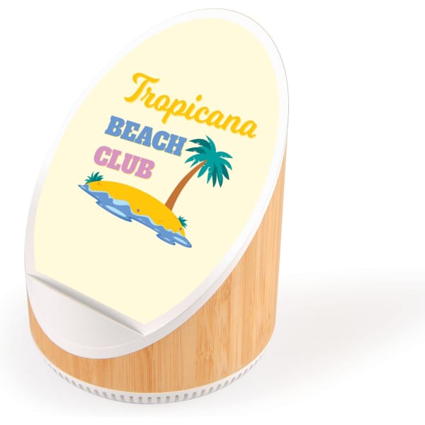 A wireless speaker and charger with a bamboo base and a cream circular top, featuring a tropical design and logo.