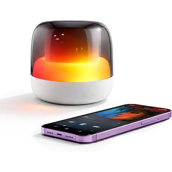 A Dazzle RGB Speaker with a glowing orange and yellow light beside a purple smartphone playing music.