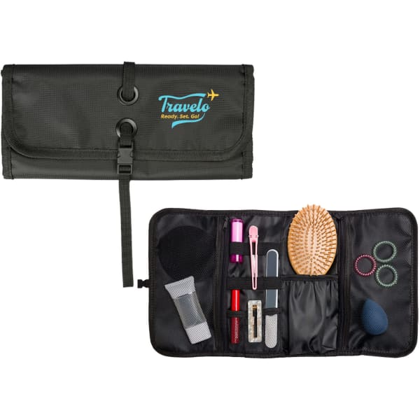 A green toiletry bag with a logo, containing a hairbrush, cosmetics, hair ties, and other accessories.