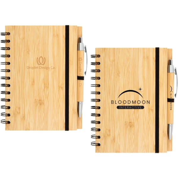 A bamboo notebook with a spiral binding and a black elastic band, accompanied by a pen, both featuring logos.