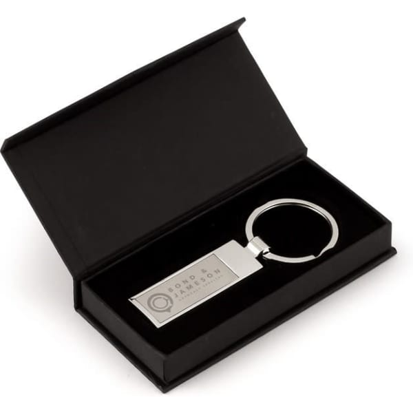 A slim chrome keyring in a black presentation box. The keyring features a polished silver finish.