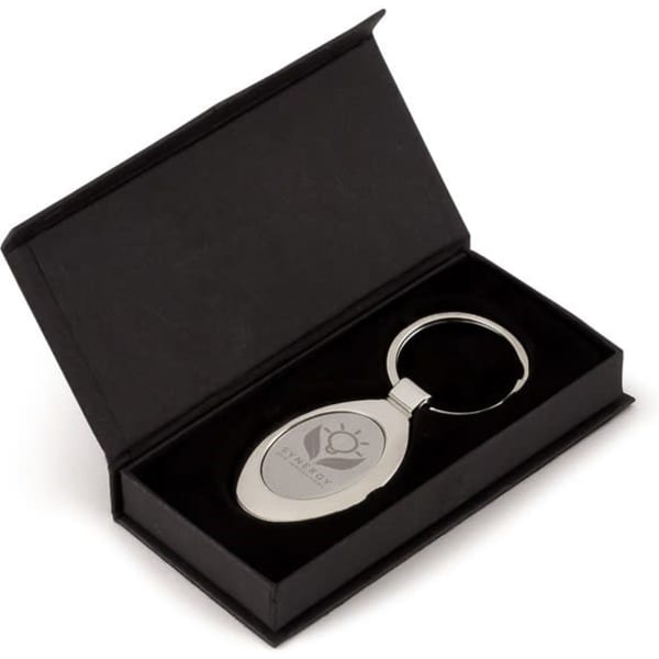 An oval silver keyring presented in a black box with a velvet interior.