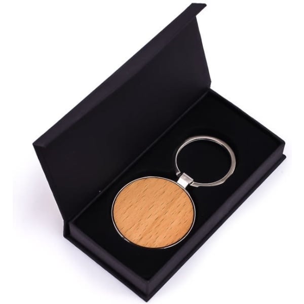 A round wooden keyring in a black gift box, featuring a silver keyring attachment.
