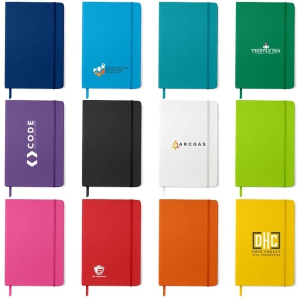 A collection of Pacific A5 Notebooks in various colours, featuring different logos and branding.
