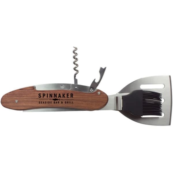 A multi-function BBQ tool featuring a wooden handle, stainless steel spatula, bottle opener, and brush.