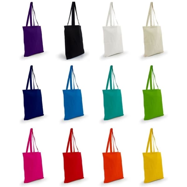 A collection of cotton tote bags in various colours: purple, black, white, navy, blue, turquoise, green, orange, red, and more. Each bag has handles and a simple design.
