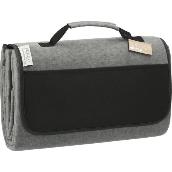 A grey oversized picnic rug with a handle, featuring a black pocket and a logo on the side.
