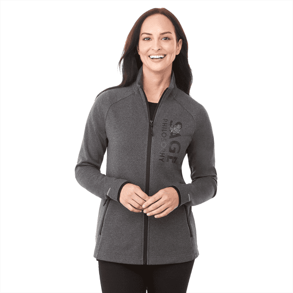 A woman in a grey jacket with a logo, featuring a zip front and high collar.