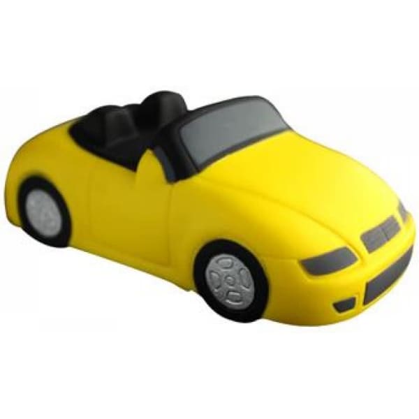 A yellow stress relief toy shaped like a convertible sports car with black seats and wheels.