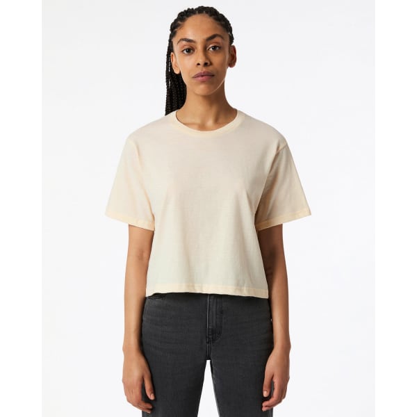 A light beige boxy t-shirt featuring short sleeves and a round neck, displayed on a model.