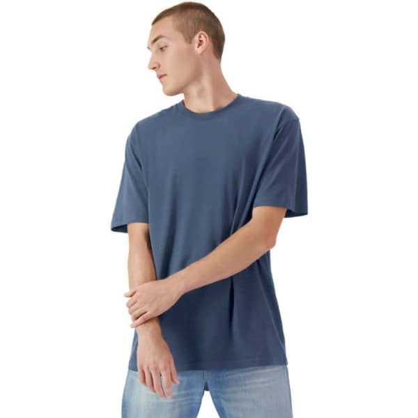 A unisex faded heavyweight cotton t-shirt in a deep blue colour, featured on a model with short sleeves.