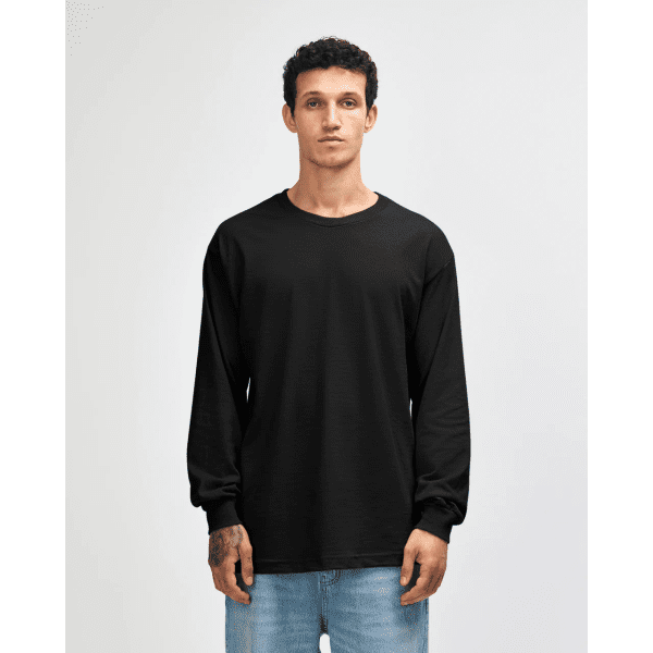 A black heavyweight cotton unisex long sleeve t-shirt displayed on a model, featuring a simple design and relaxed fit.