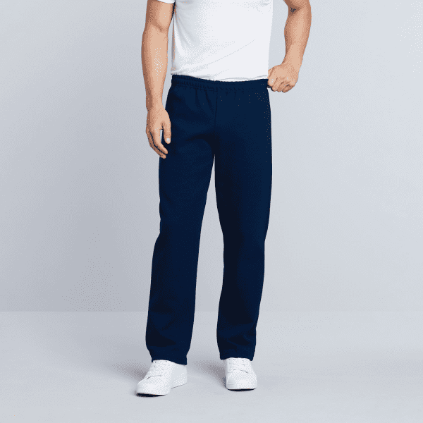 Navy blue heavy blend adult open bottom sweatpants with an elastic waistband, worn by a model in a white t-shirt.