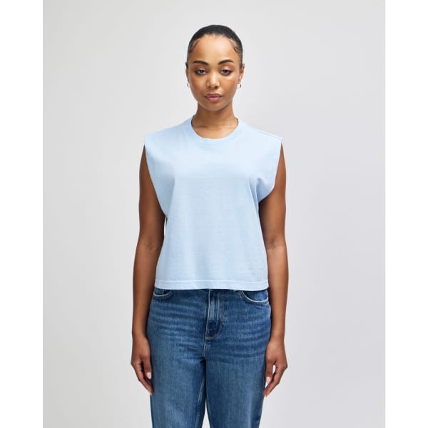 A light blue muscle T-shirt with a relaxed fit and sleeveless design worn by a model.