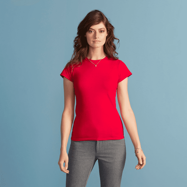 A red Softstyle ladies' T-shirt displayed on a model against a light blue background.