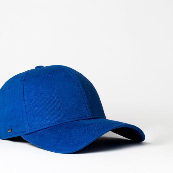 A blue fitted cap featuring six panels and a small logo on the side.