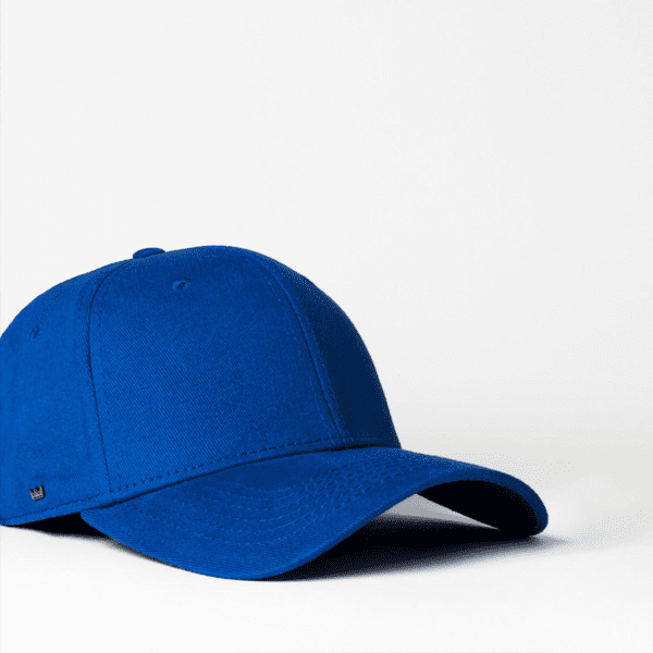 A blue fitted cap with six panels, featuring a logo on the side.