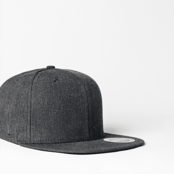 A fitted flat peak cap in dark grey with a circular logo on the front panel.
