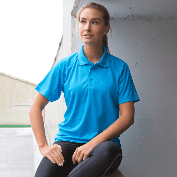 A bright blue polo shirt with short sleeves, featuring a collar and three buttons, displayed on a model.
