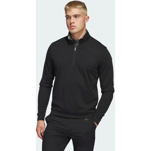 A black quarter zip pullover jumper featuring a high collar and long sleeves, with a logo on the front.