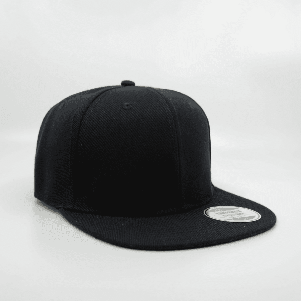 A black snapback cap with a flat brim and a branded label on the side.