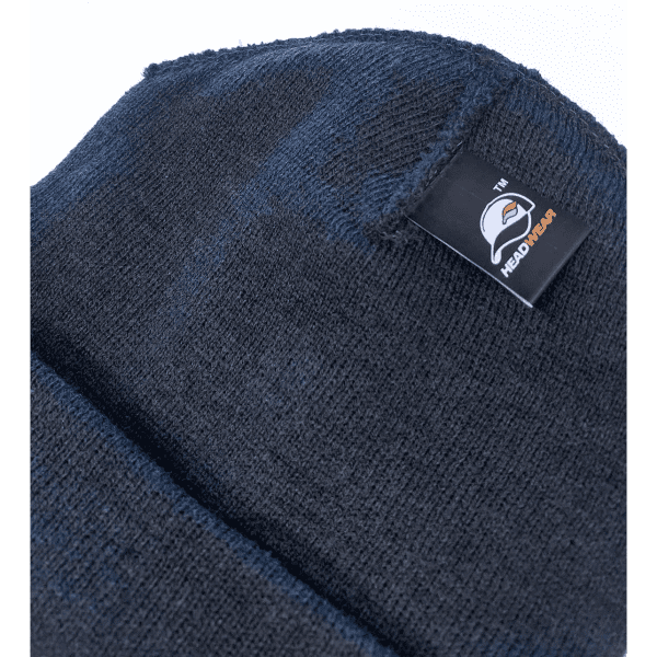 A dark blue beanie with a textured fabric and a logo tag on the side.