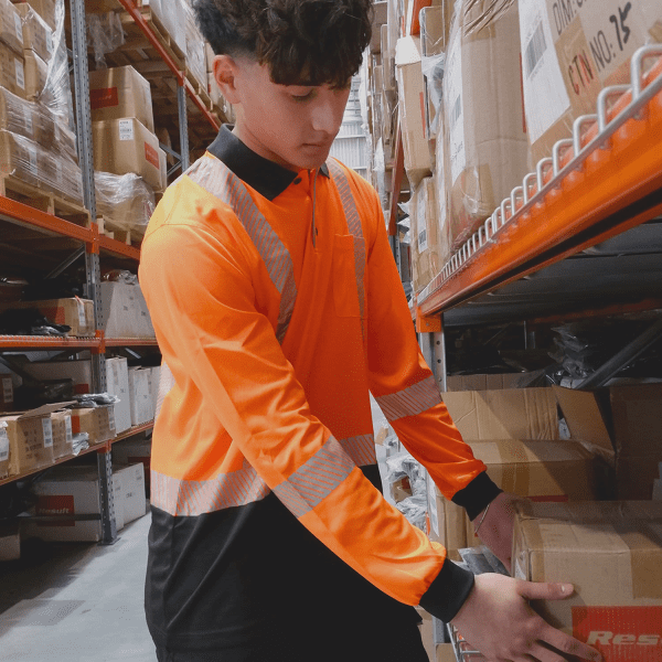 A long sleeve polo shirt in high visibility orange and black, featuring reflective strips and a logo.