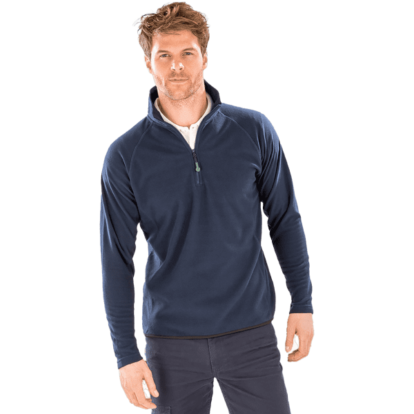 A navy blue quarter-zip fleece top on a model, featuring a zip collar and casual styling. The garment includes a logo.