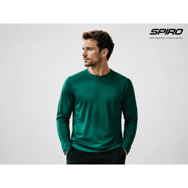 A man models a long-sleeve, green Spiro performance shirt, featuring a logo on the side.