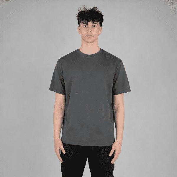 A grey fleece tee is displayed on a model, featuring a relaxed fit and a simple design. The tee has a logo.