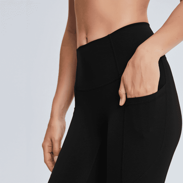 Black high-rise training full tights with a side pocket, showcasing a fitted design and stretchy material.