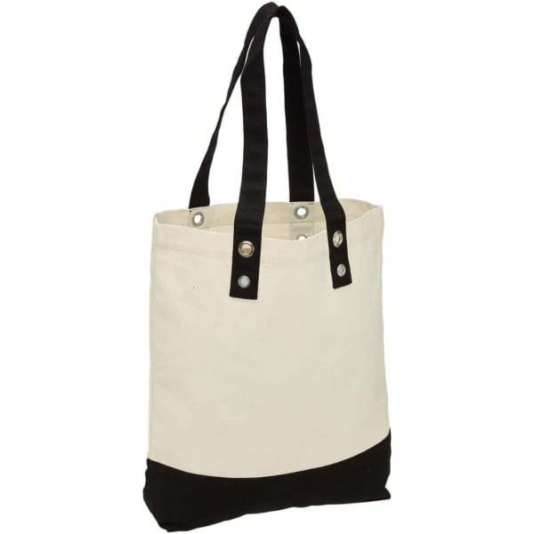 A cream canvas tote bag with a black base and black handles, featuring metal studs and a logo.