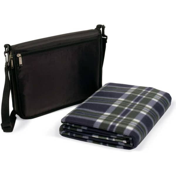 A black bag with a zippered compartment next to a folded plaid picnic rug in dark green and navy.