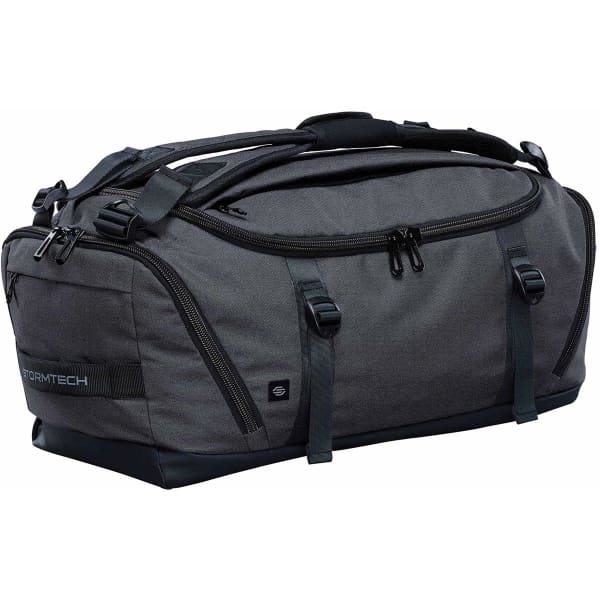A grey duffle bag with multiple zippered compartments and carry handles. It features a logo and a sleek design.