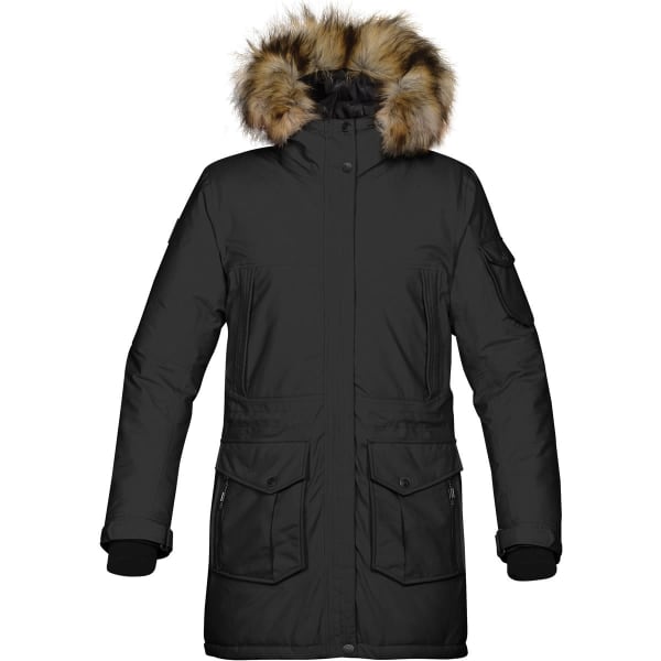 A black women's expedition parka with a fur-lined hood and multiple pockets. It has a logo on the sleeve.