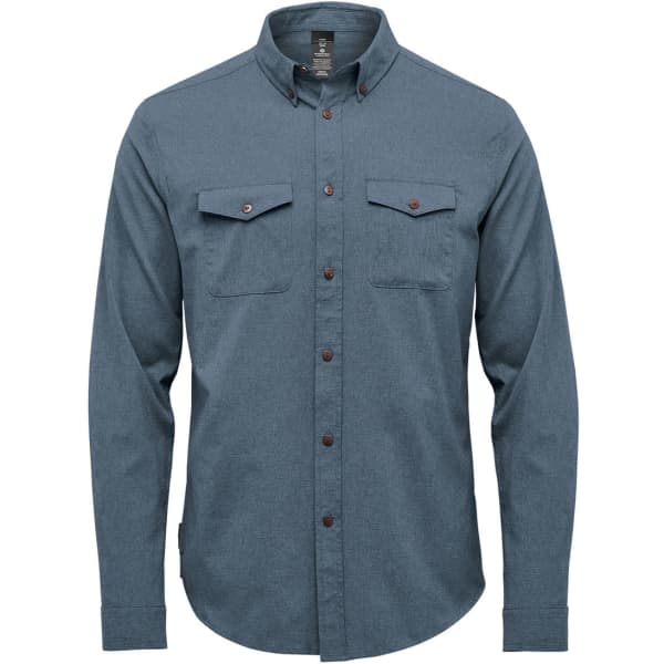 A men's button-up shirt in a blue-grey hue featuring two breast pockets and a collar. It includes branding labels.