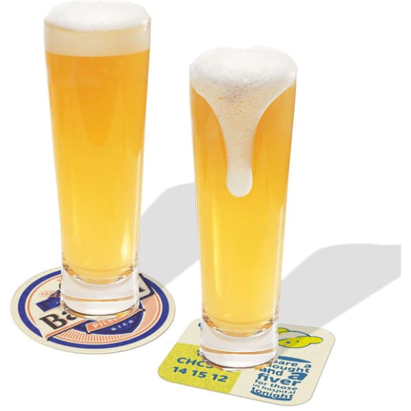 Beer coasters in various colours with two glasses of pale beer, one with a frothy head.
