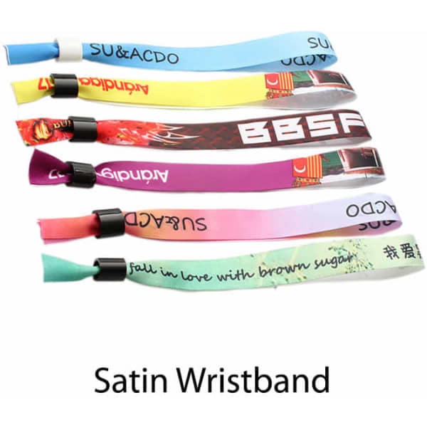A collection of satin wristbands in various colours, featuring different patterns and a logo on each band.