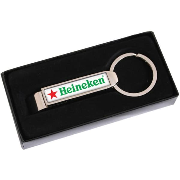 A drink bottle opener in silver with a circular keyring and a branded logo, presented in a black box.