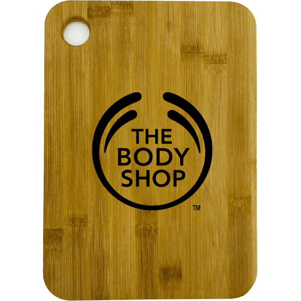 A large bamboo cutting board with rounded corners, featuring a logo on the surface.
