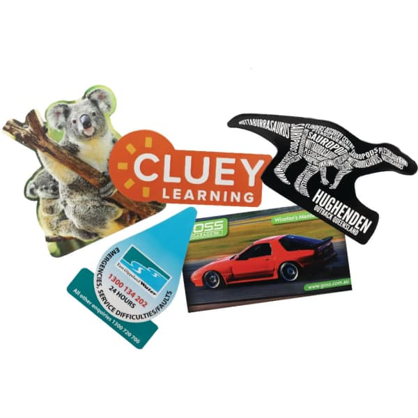 Custom magnets in various shapes and colours, featuring a koala, a car, a dinosaur, and a logo.