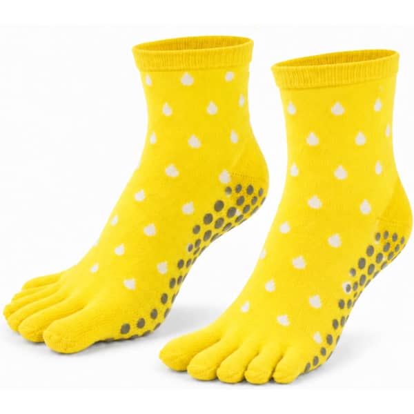 A pair of yellow ankle toe socks with white polka dots and grey grips on the soles. It features a logo.