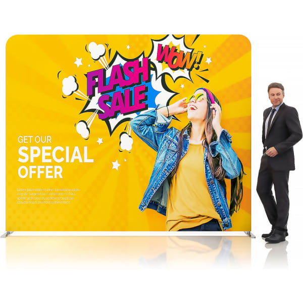 A vibrant, yellow fabric display wall featuring a graphic design with text and a person wearing sunglasses. It has a logo.