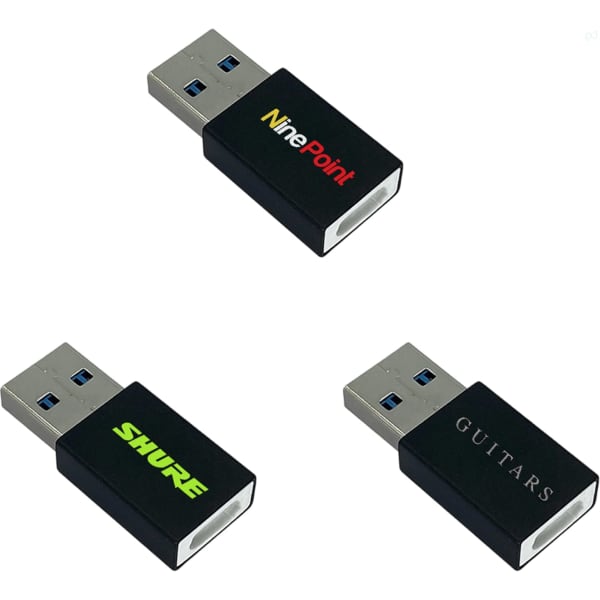 A set of three black USB data blockers with different logos, featuring standard USB connectors.